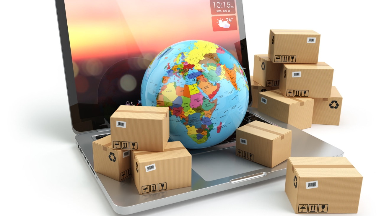Shipping, delivery and logistic concept. Earth and cardboard boxes on laptop keyboard. Online technology. 3d